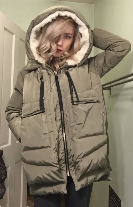 A reviewer styling the green coat.