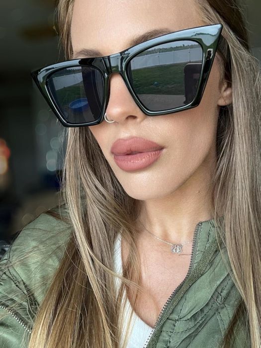 The reviewer is wearing black sunglasses.