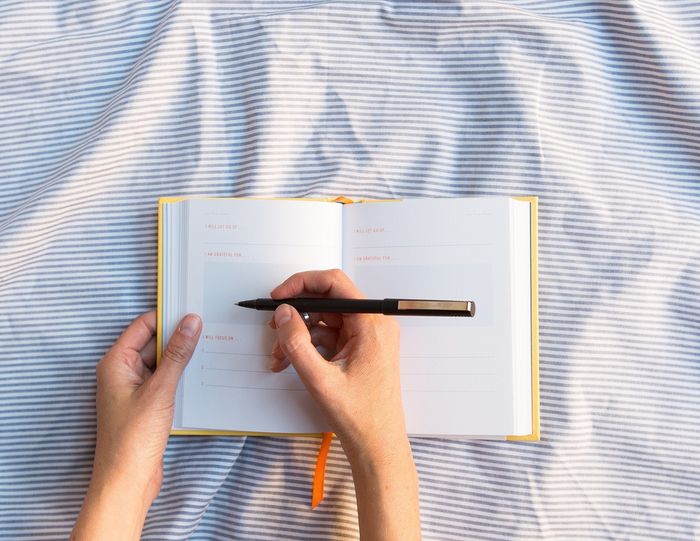 a person writing in the journal