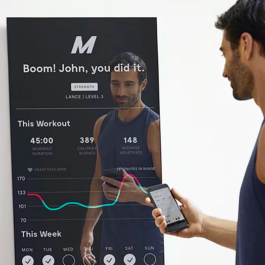 The same model tracking their progress on the mirror through their phone.
