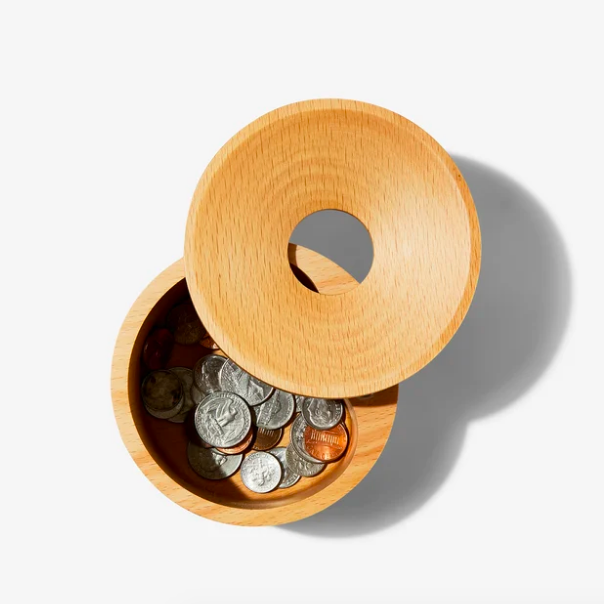 The lid twisted open, revealing coins inside