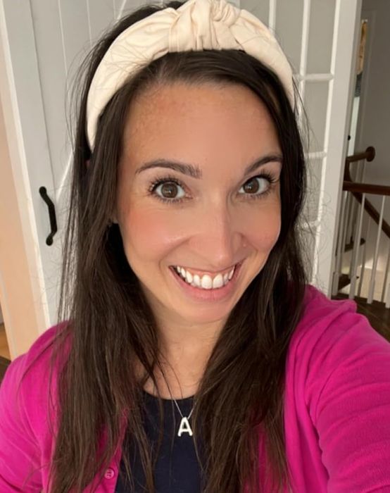 The reviewer is wearing a gold A necklace.