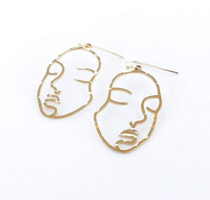 The bold gold face statement earrings
