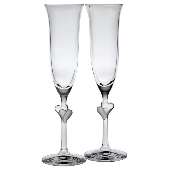 The champagne flutes adorned with hearts on the stems
