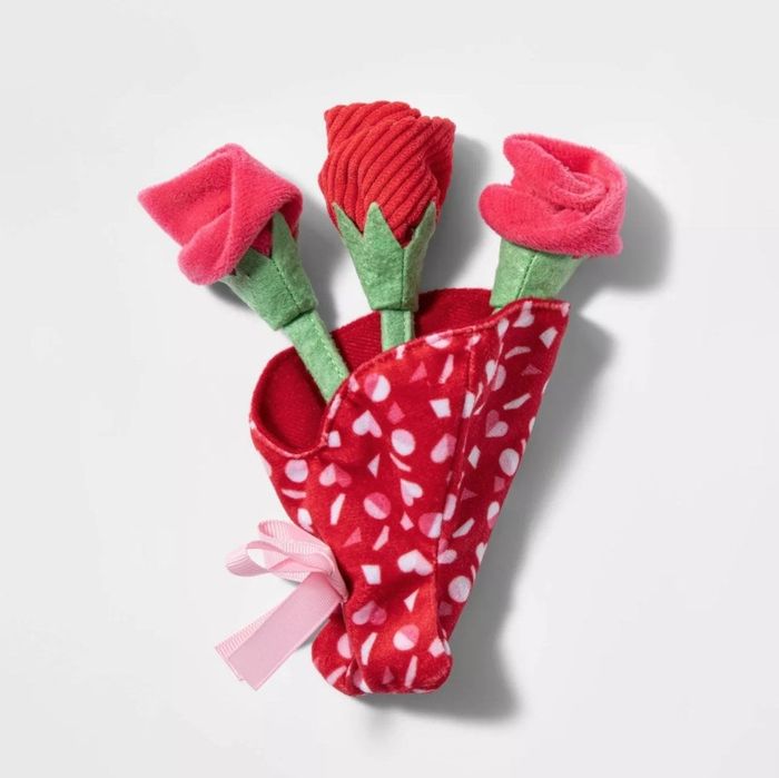 The toy roses nestled in a soft vase
