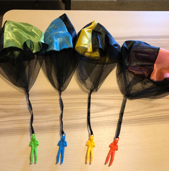A photo from a reviewer featuring four parachute toys