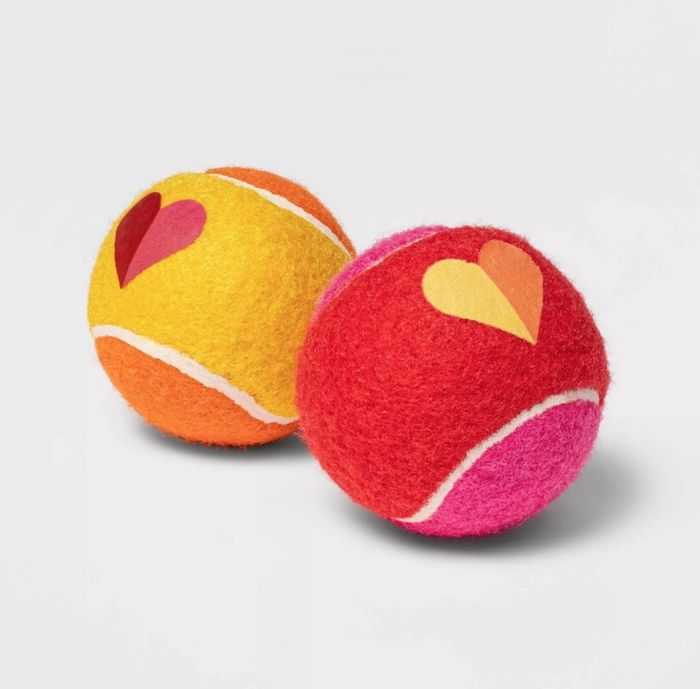 The tennis balls decorated with hearts.