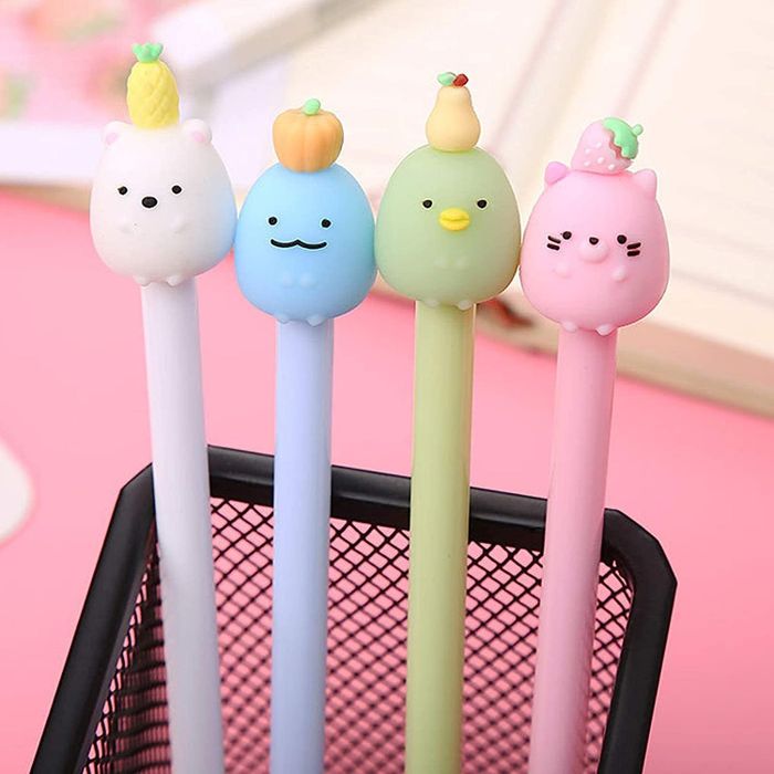 Pens with animals wearing fruits on their heads