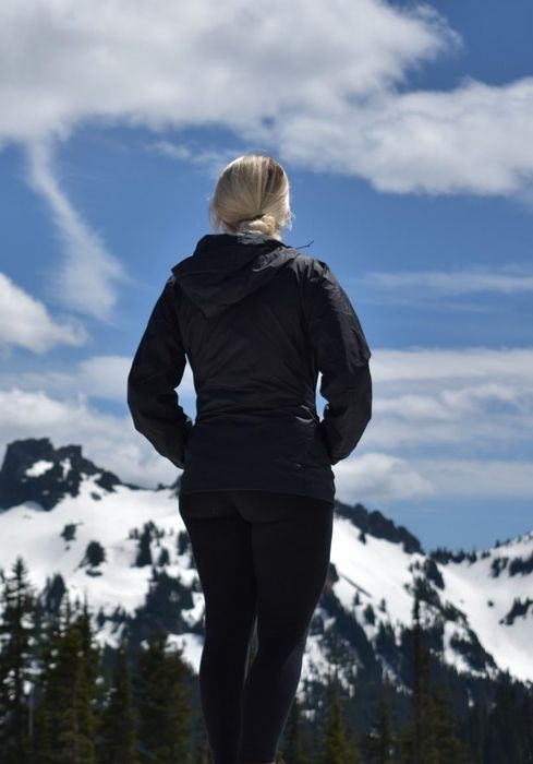 A reviewer showcasing the coat in a stylish black color