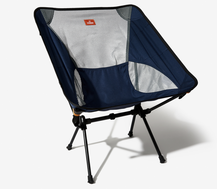 A navy camp chair with a gray mesh backrest.