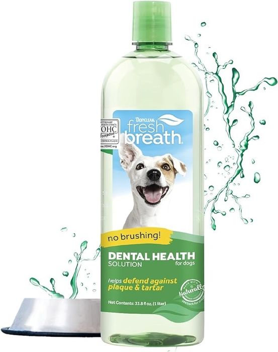 A bottle of TropiClean Fresh Breath dental health solution for dogs, featuring a dog’s image, water splashes, and text emphasizing benefits like plaque and tartar defense.