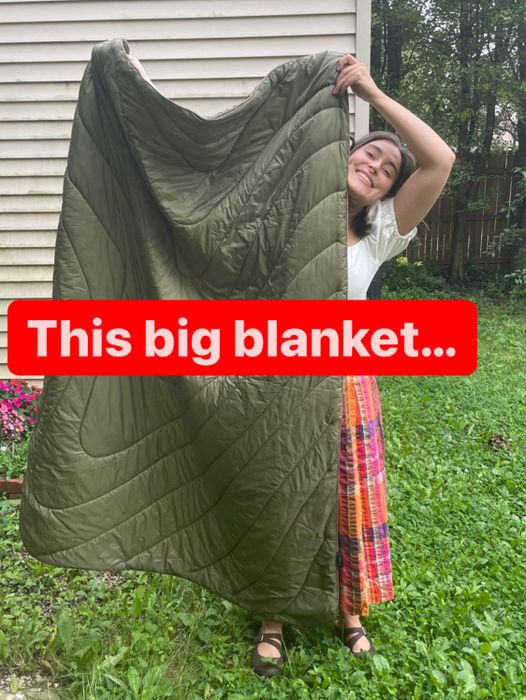 The author holding the blanket up with the caption: