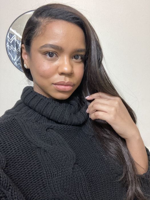 The writer shows off their smooth hair after using the satin beanie.