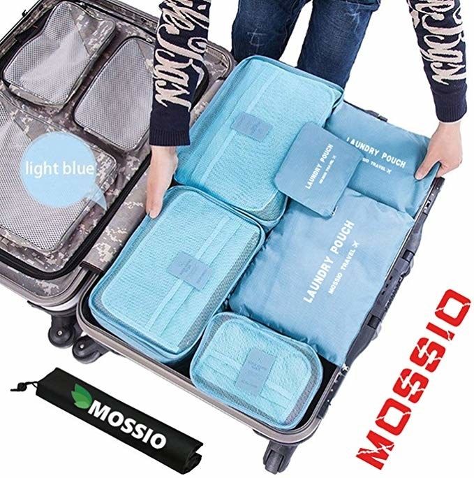 Blue packing cubes neatly stacked inside a suitcase.