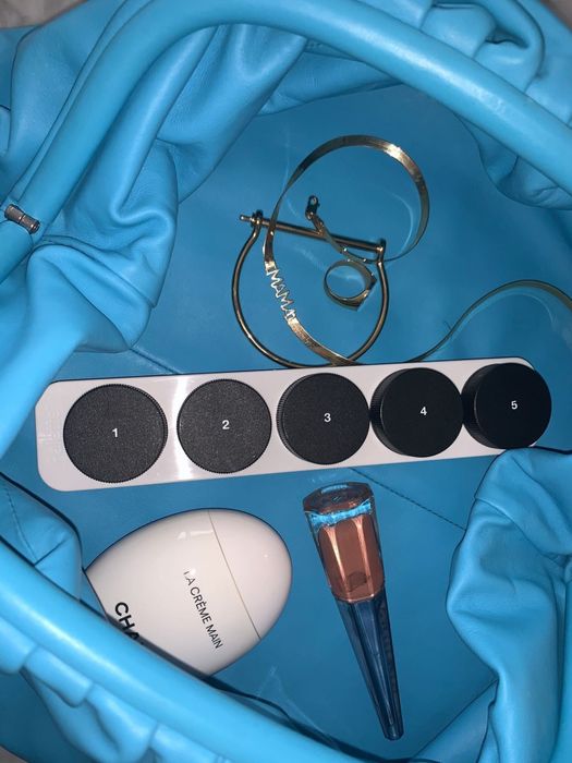 The black and white Palette refillable holder tucked into a blue bag