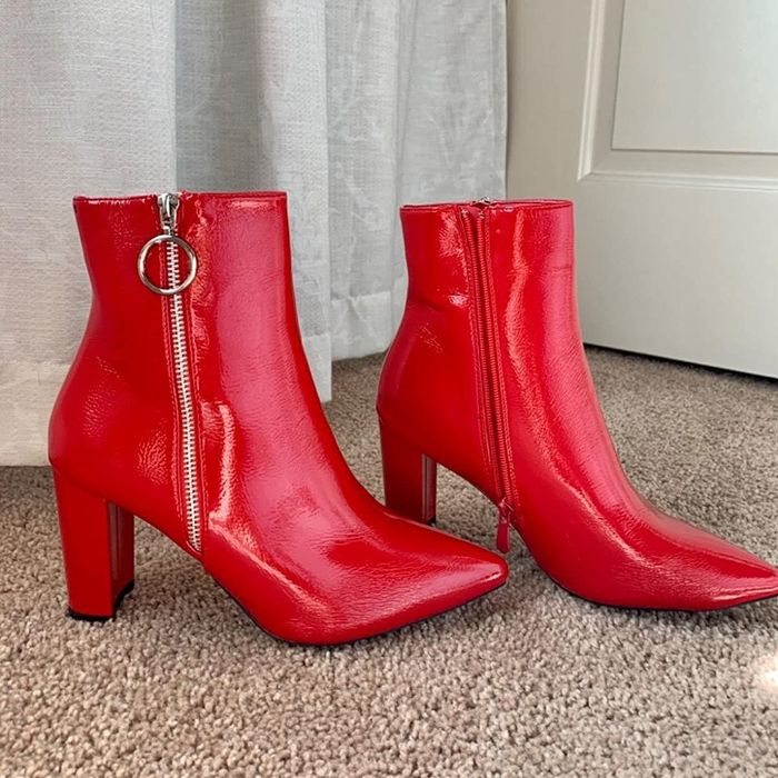 A photo from a reviewer showing off the red boots with a side zip and a silver ring pull tab.