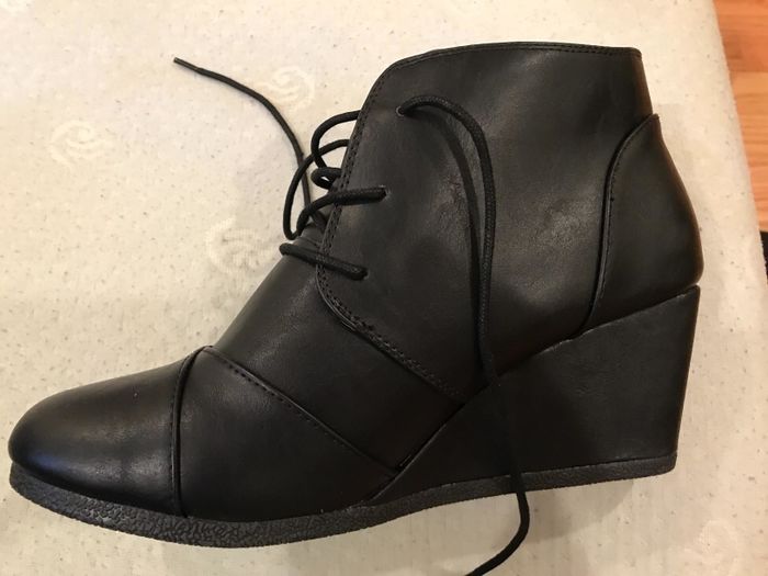 A reviewer’s image showcasing the wedge bootie in classic black.