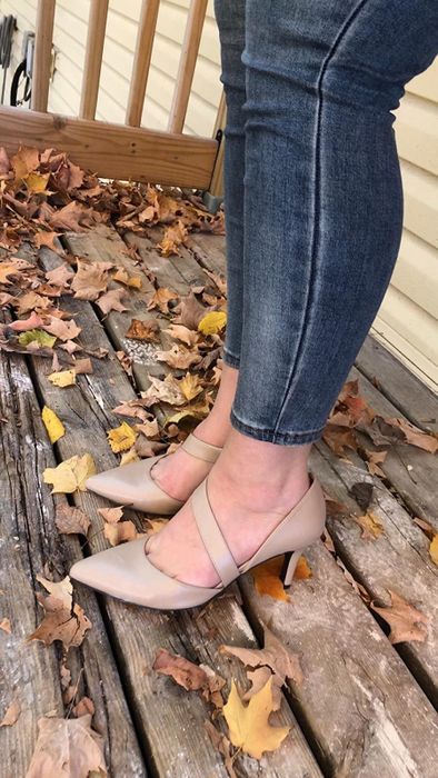 a reviewer wearing tan pointed-toe pumps