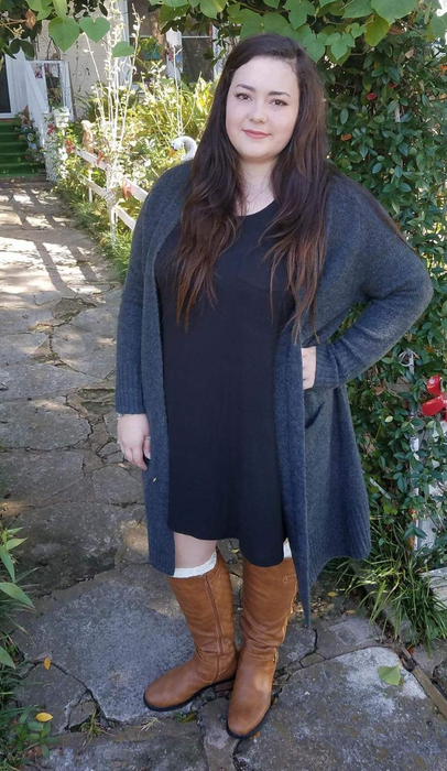 a reviewer striking a pose in brown boots