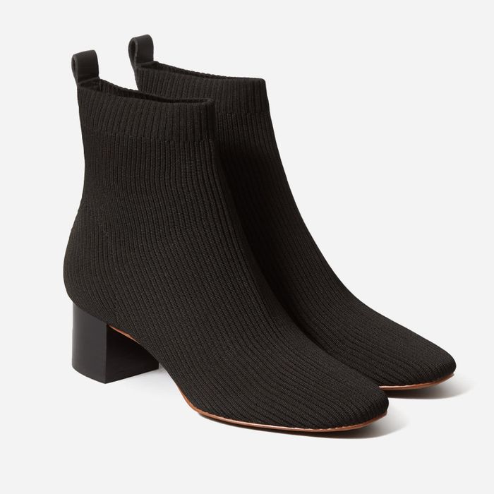 A pair of black heeled knit booties.