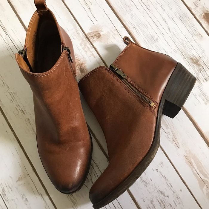 A reviewer shows a picture of the boots in brown faux leather.