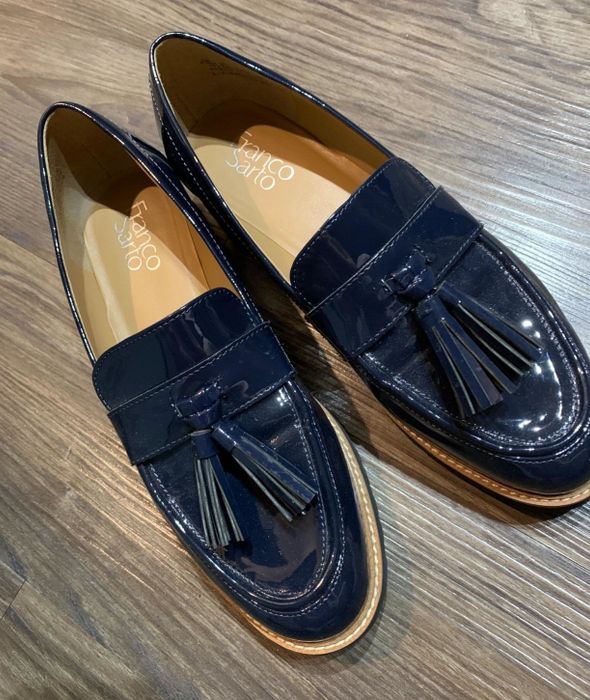A reviewer’s photo of navy patent loafers with tassel detailing.