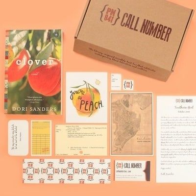 A top-down view of a box, a book, various documents, maps, a library, and more arranged creatively.