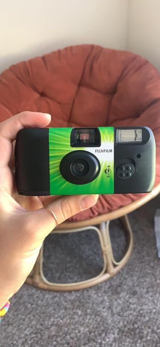 A reviewer demonstrating how to hold the camera