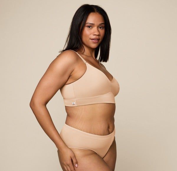 model wearing a beige bralette paired with high-waisted panties
