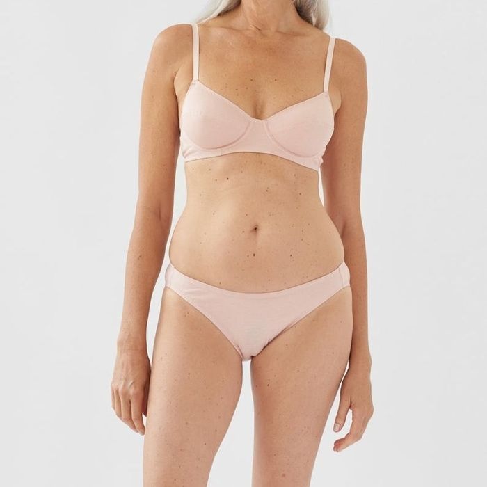A model showcasing the beige bra with matching underwear.