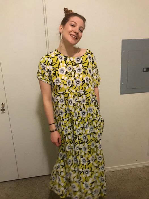 A reviewer seen wearing the yellow and white Bohemian floral dress.