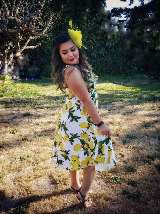 Reviewer wearing the yellow lemon print sleeveless flared A-line dress