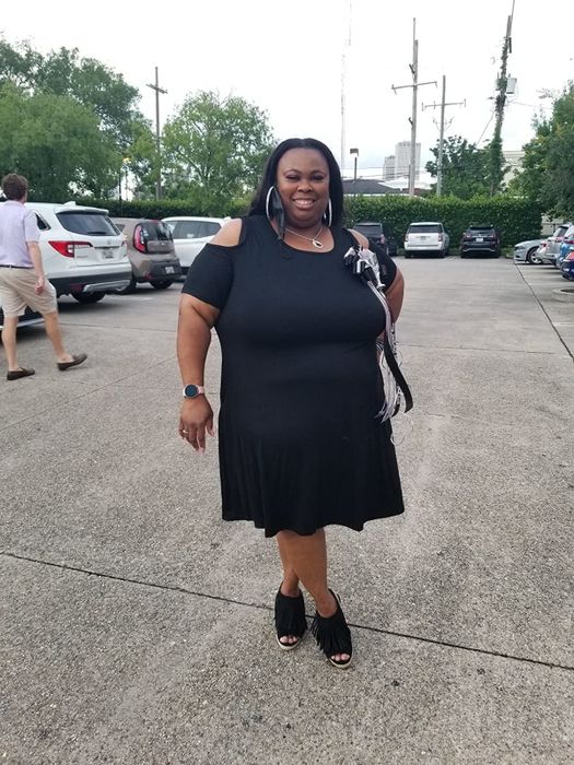 Reviewer wearing the black cold shoulder T-shirt dress