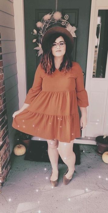 Reviewer wearing the long-sleeve caramel flowy tunic dress