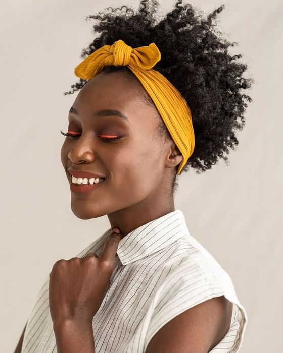 Model showcasing the yellow ribbed band tied in a knot at the top