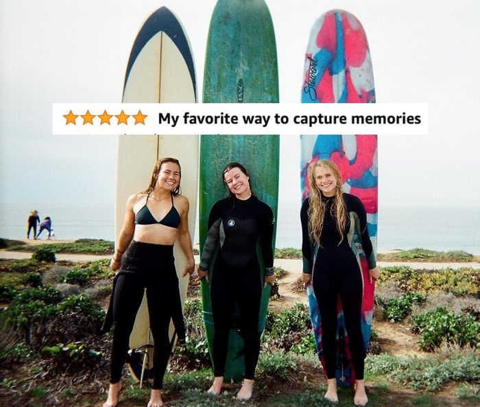 A reviewer's photo showing three surfers with a caption