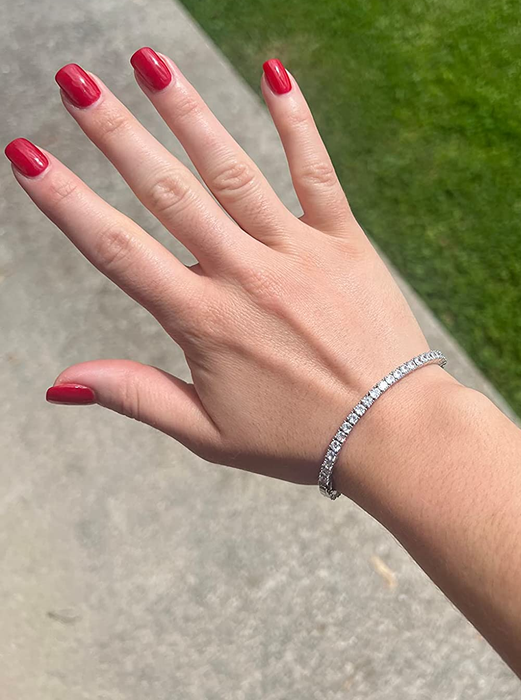 A hand showcasing the CZ tennis bracelet