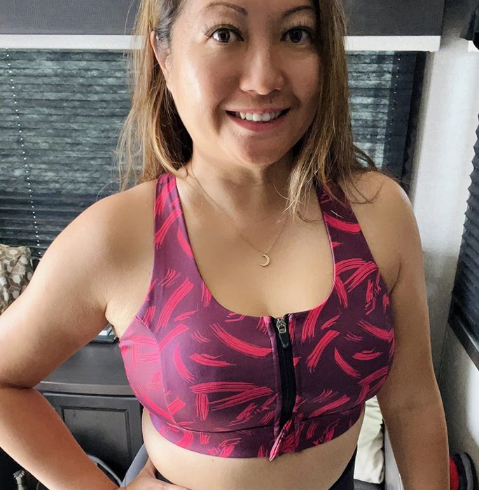 a reviewer showcasing the bra in a pink and purple combination