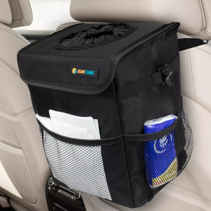A car backseat organizer with a tissue holder and storage compartments, featuring the