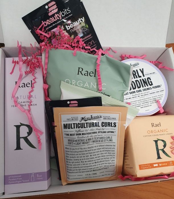A reviewer’s photo showing an open box filled with beauty products from different brands