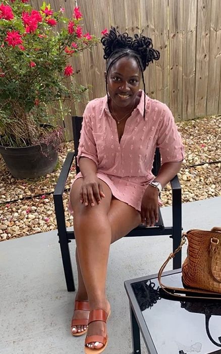 A reviewer is wearing the pink dress.