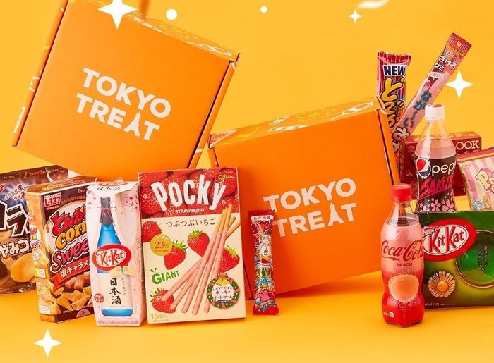 Two vibrant orange boxes labeled 'TokyoTreat,' surrounded by an assortment of snacks.