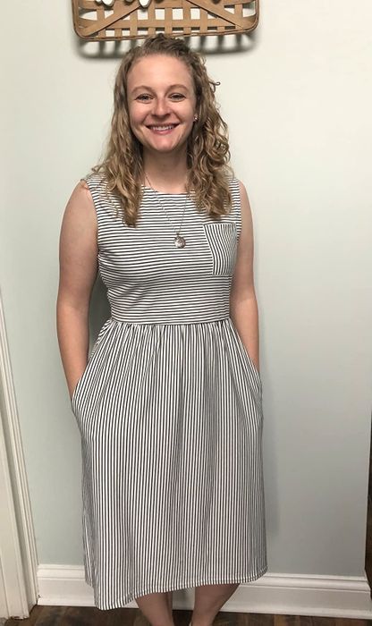 A reviewer is seen rocking the black-and-white sleeveless dress.