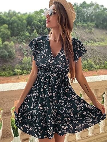 A model is wearing a black floral dress.