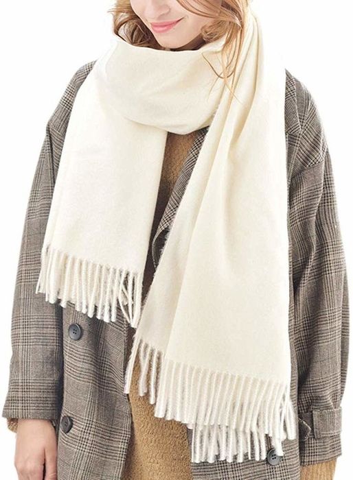 Model wearing the cream-colored scarf with fringe