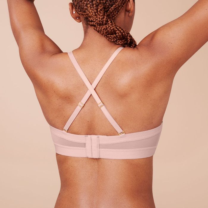 Another model presents the blush-colored bra, featuring crisscross straps at the back for a trendy touch.