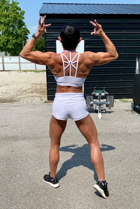 The back view of the reviewer wearing a white bra, highlighting the elegant design.