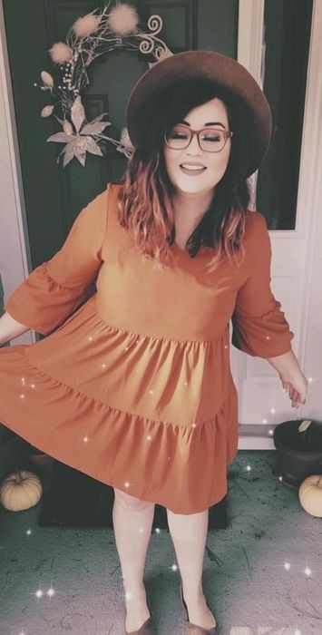 Reviewer wearing the long-sleeve caramel flowy tunic dress