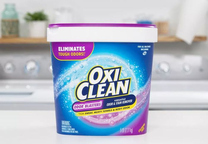 OxiClean Detergent Container on Countertop Promoting Stain and Odor Removal