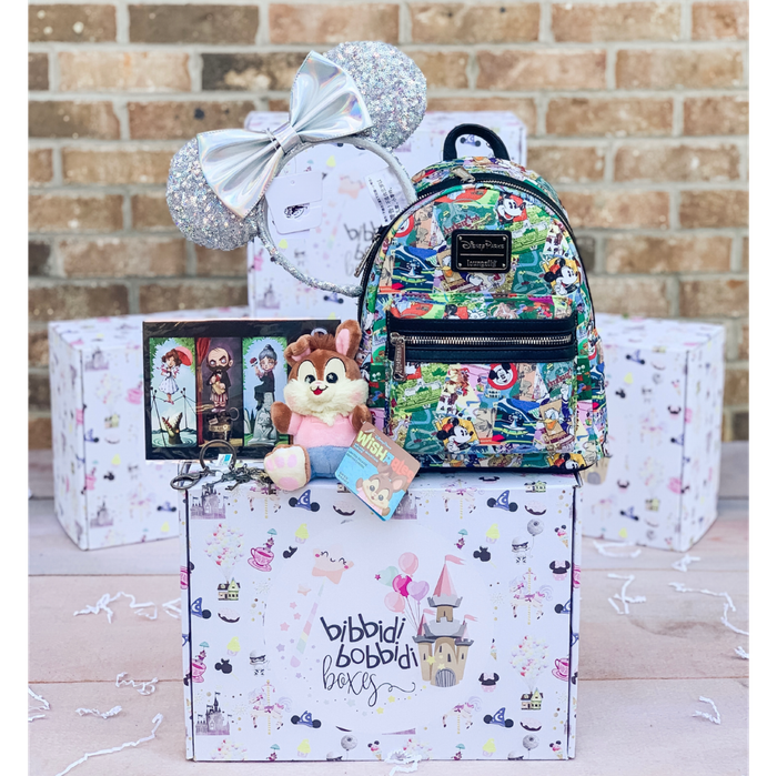 The ultimate magic box from Bibbidi, pictured here, includes a Disney plush toy, a Loungefly backpack, Minnie Mouse ears, and two other Disney-themed items.